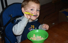 Boy Eating Out of Green Bowl