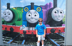 Boy in front of trains