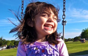 Girl smiling on swing