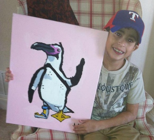 Boy with hemiplegic cerebral palsy paints during occupational therapy